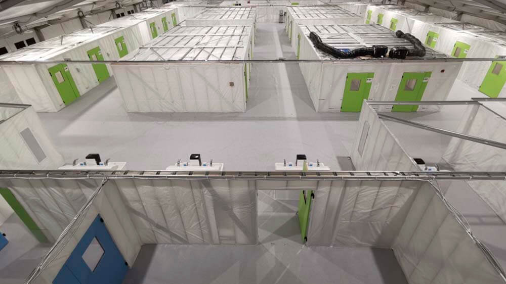 Medical Facility — Modular Rooms in Clearspan Structure Interior of clearspan fabric structure configured as medical facility with modular patient rooms and HVAC