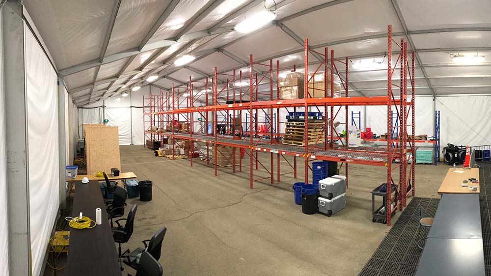 Temporary Warehouse Interior — Clearspan Fabric Building Interior of clearspan fabric warehouse with industrial pallet racking, workstations, and overhead lighting