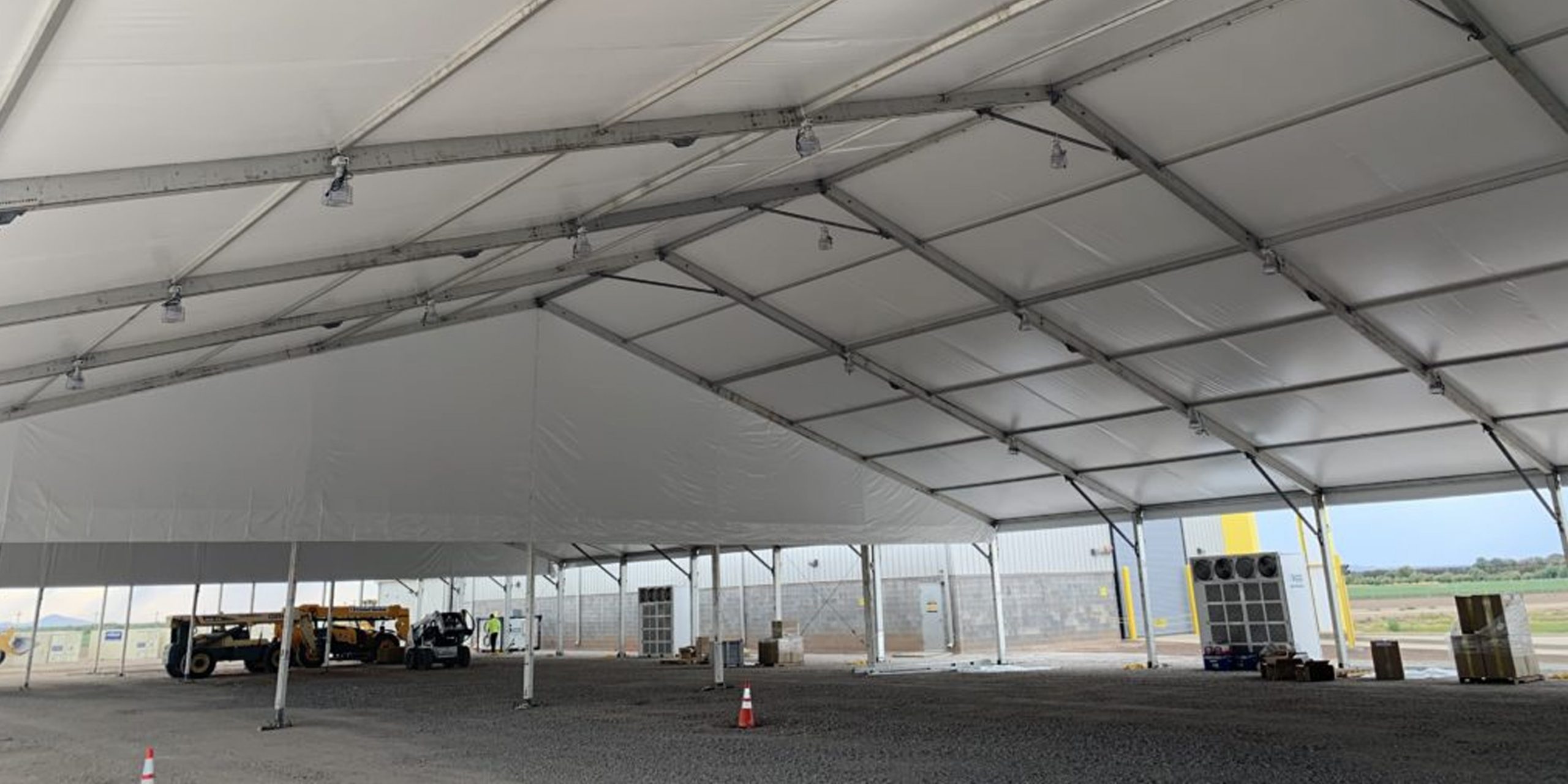 Emergency response tent configured as a command center with wide clearspan opening for disaster coordination