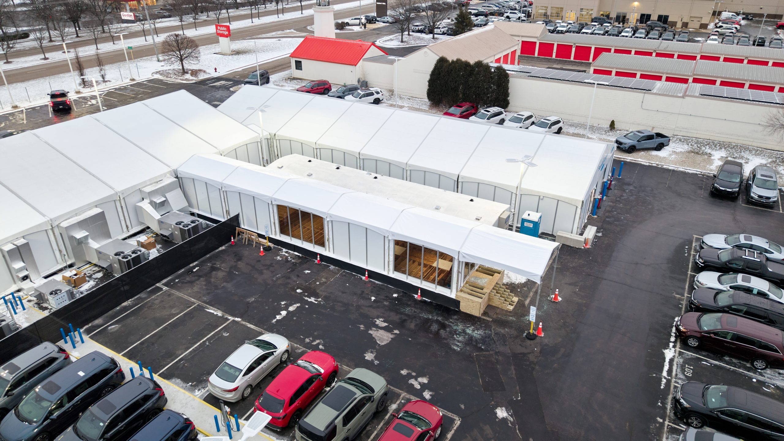 Aerial drone view of temporary office building complex with glass walls and parking — Michigan
